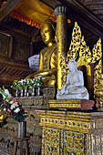 Buddha statue and decorations in ordination hall (thein) in teak Shwe Yaunghwe Kyaung Buddhist monastery, near Inle Lake. Myanmar. 